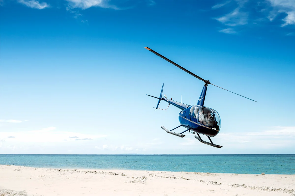 Helicopter flying over a beach